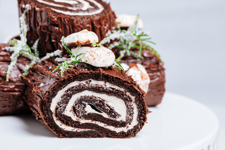 A yule log or bûche de Noël cake with meringue mushrooms