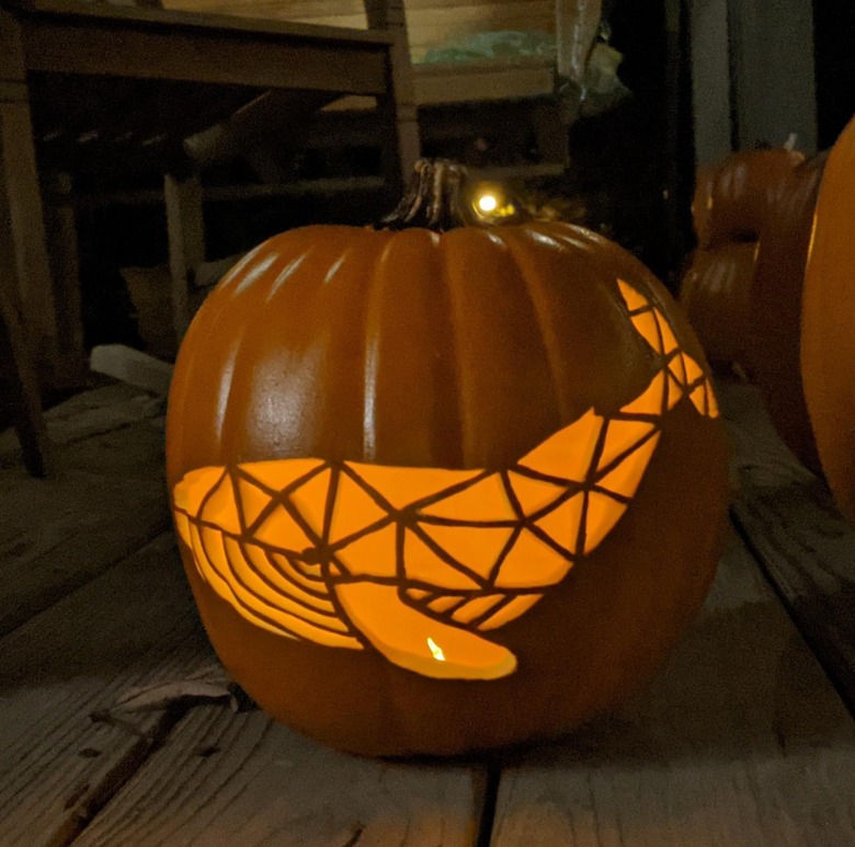 Whale carved into pumpkin.