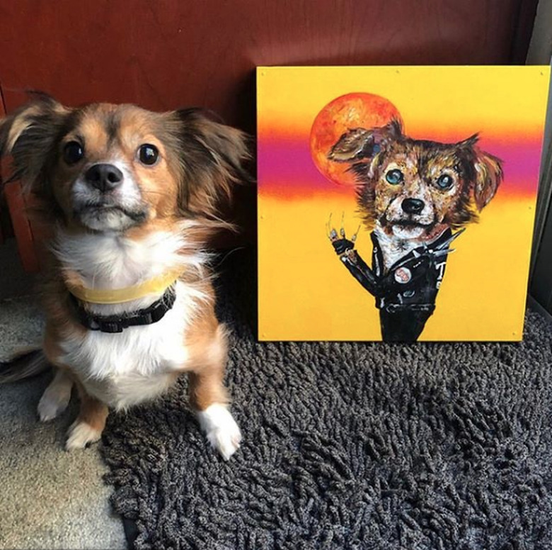 dog sitting next to his custom portrait.