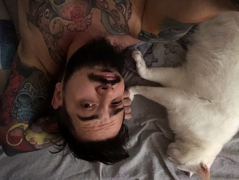 man wakes up before cat