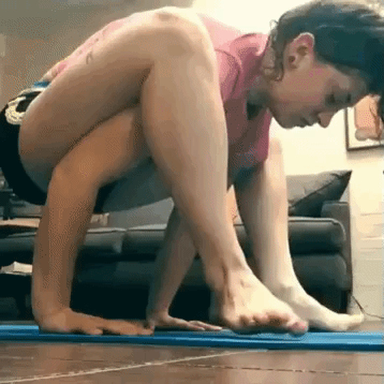 dog interupts woman doing yoga