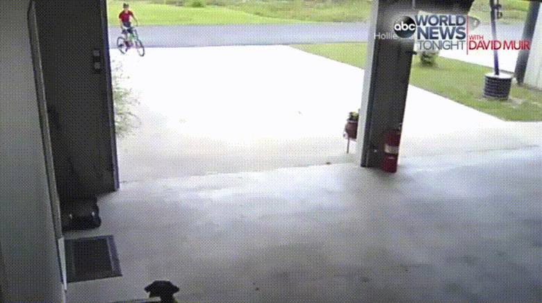 kid on bike stops to hug dog