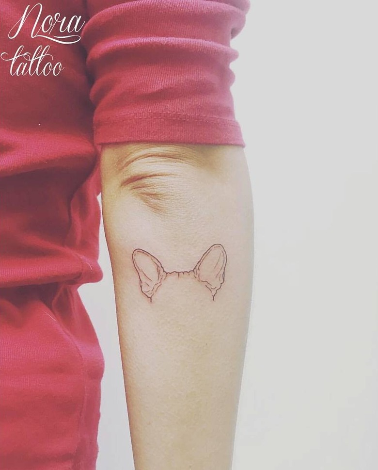 A tattoo of a dog's ears.