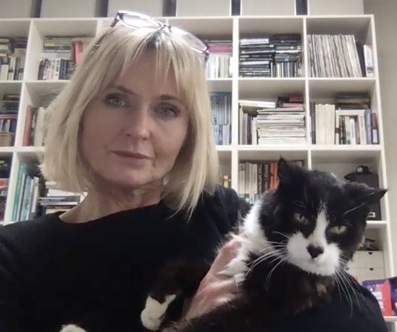 cat sits on professors shoulder during Zoom lecture