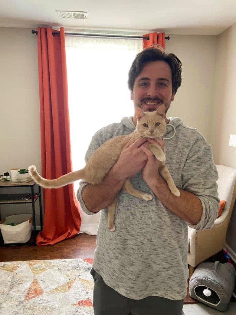 man poses picture with kitten