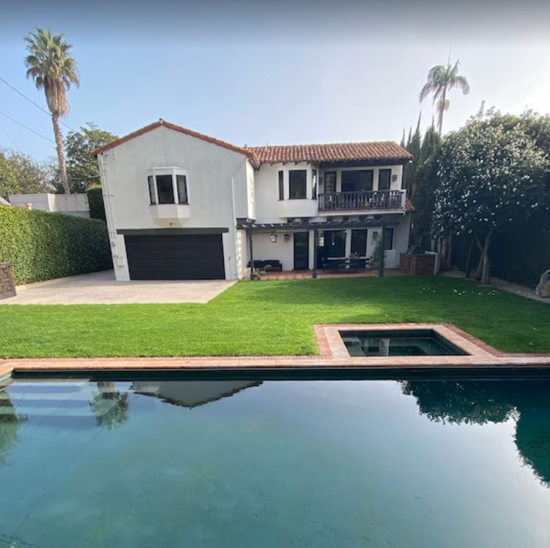 Spanish-style home in Brentwood, Los Angeles with backyard with grass and pool