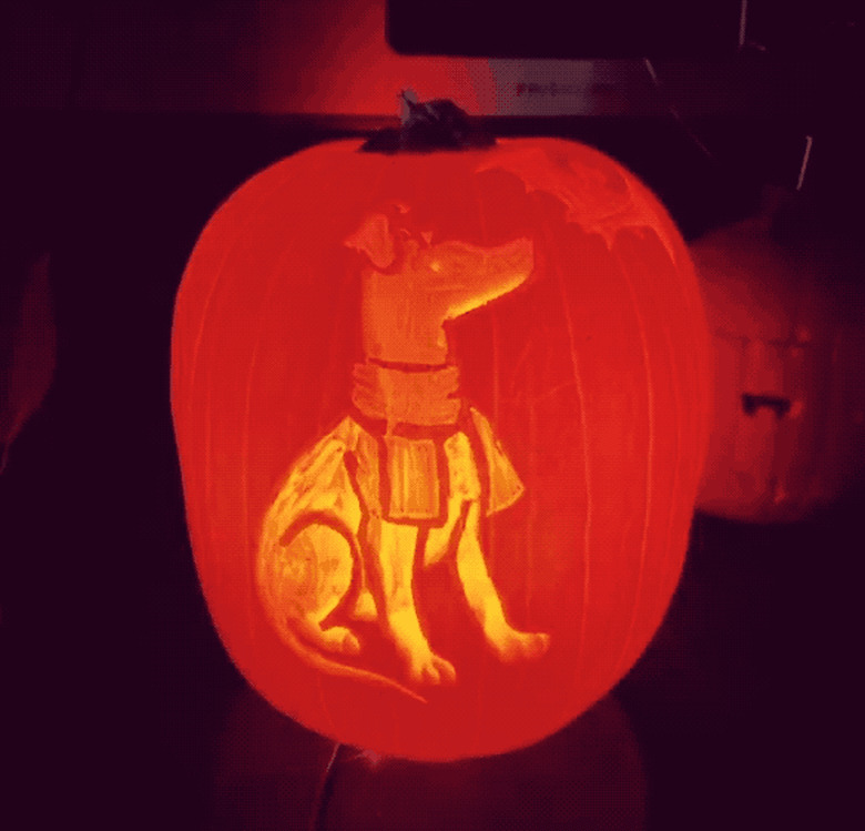 glowing pumpkin with dog carved into it