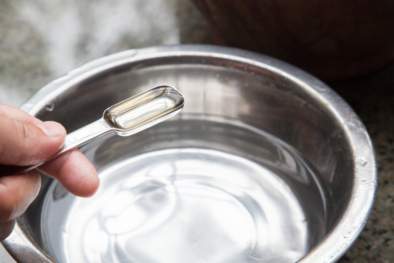 a small spoon and a metal water bowl