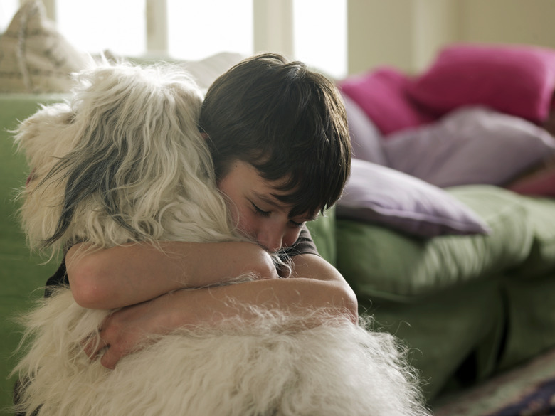 Boy hugging his dog