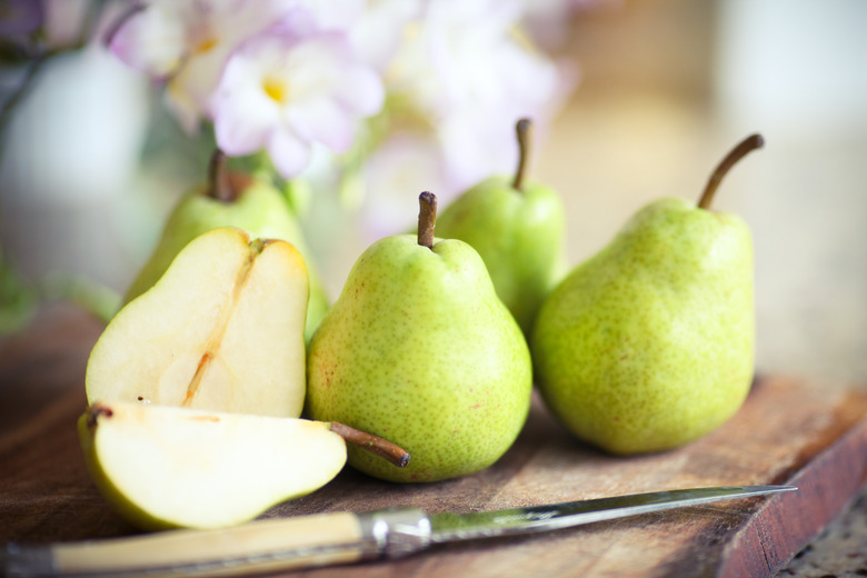 Green Pears on Wooden Board