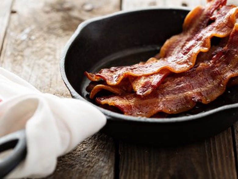 Sizzling hot bacon in a cast iron skillet