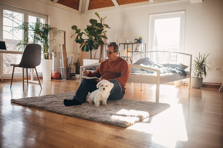 An older man is reading a book