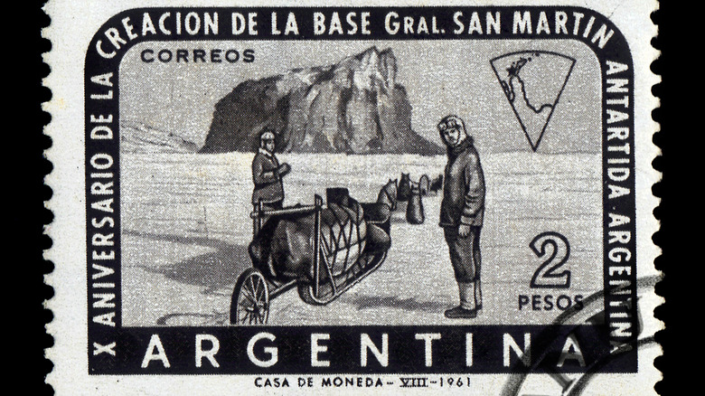 A stamp from Argentina showing  two men with sled dogs