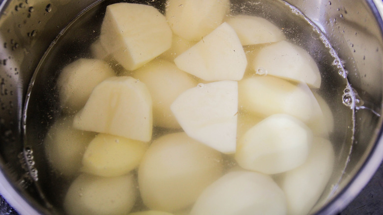 pot of quartered white potatoes in water