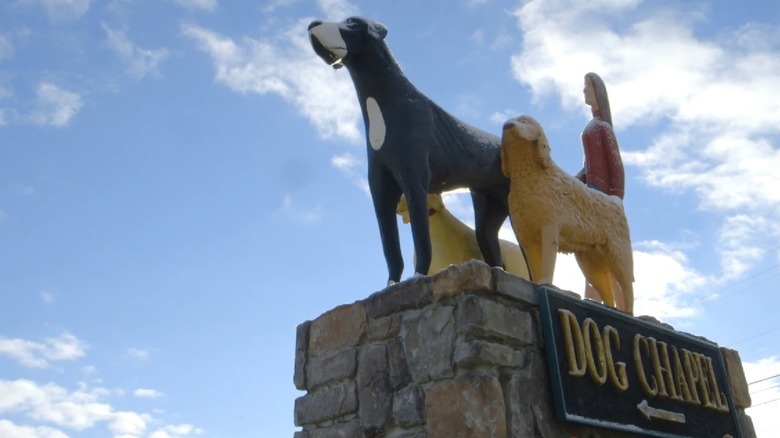 A statue of two dogs that sits in front of the chapel at Dog Mountain