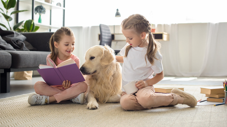 two girls with golden retriever