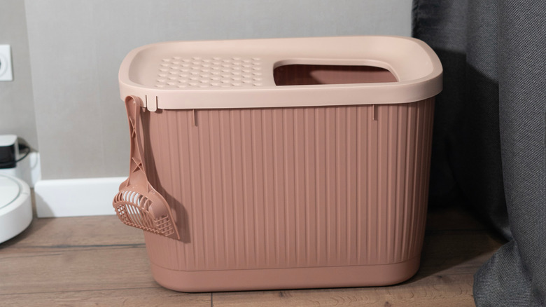 A pink high-walled top-entry litter box with scoop