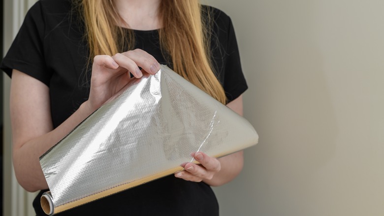 woman with tinfoil roll