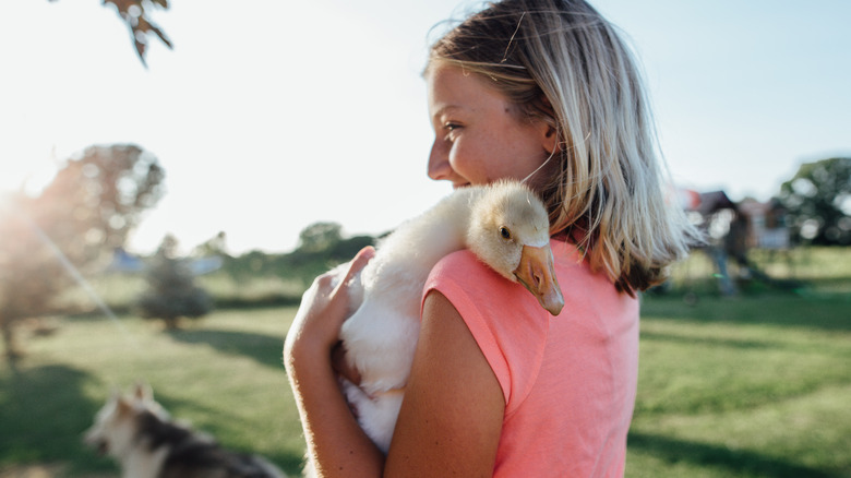 young girl holding a duck