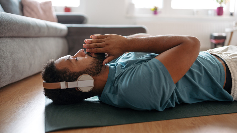 man focusing on his breathing while listening to music