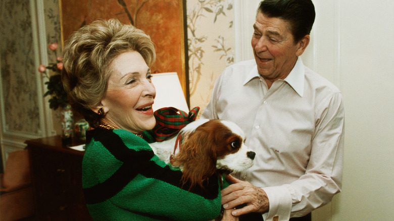 President Ronald Reagan and First Lady Nancy Reagan hold their dog, Rex