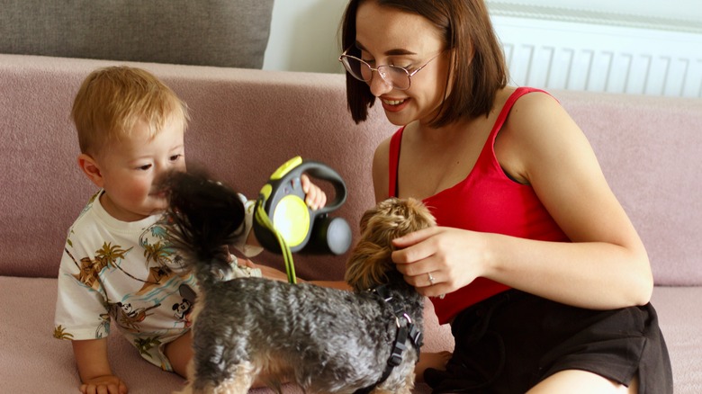 mom and small child petting yorkie