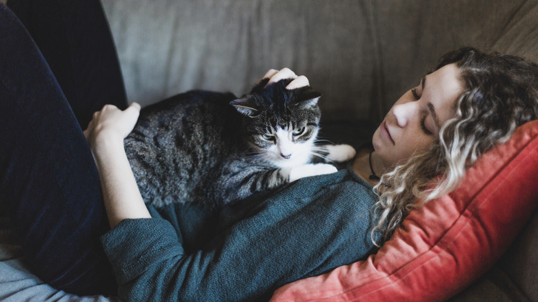 woman lying down with her cat